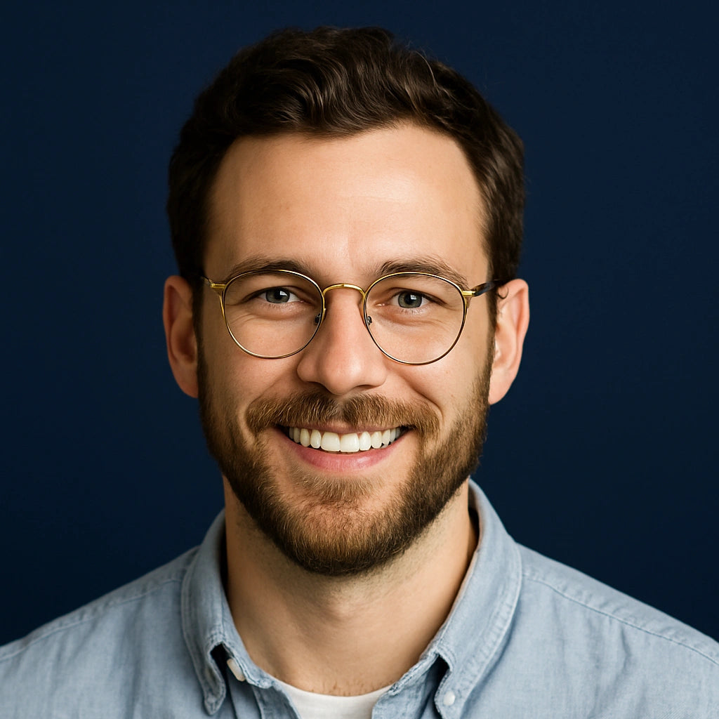 Professional headshot of Ethan Mercer, Project Manager at Authority Ink Press, smiling in front of a dark blue studio background.