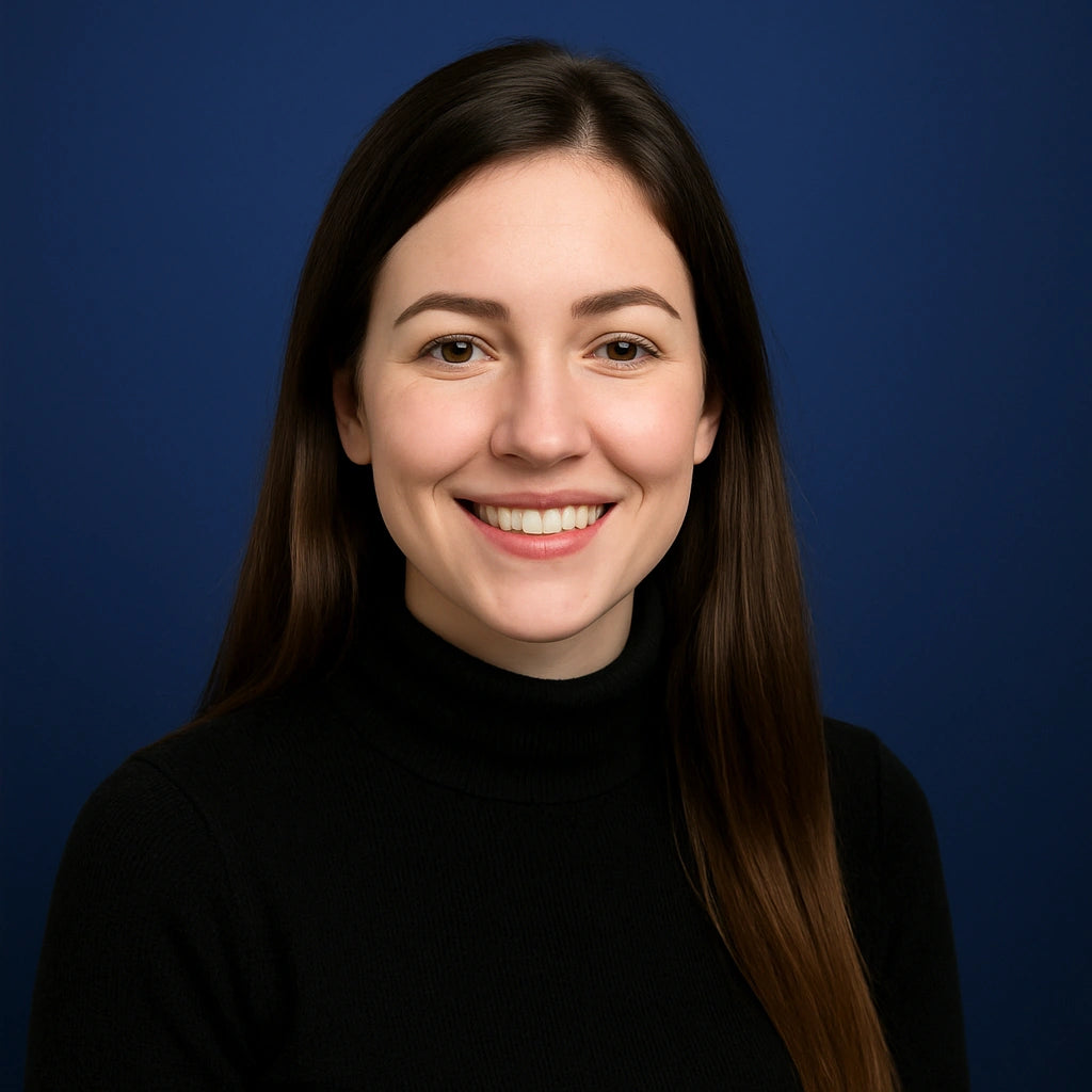 Professional headshot of Hailey Monroe, Project Manager at Authority Ink Press, smiling in front of a dark blue studio background.