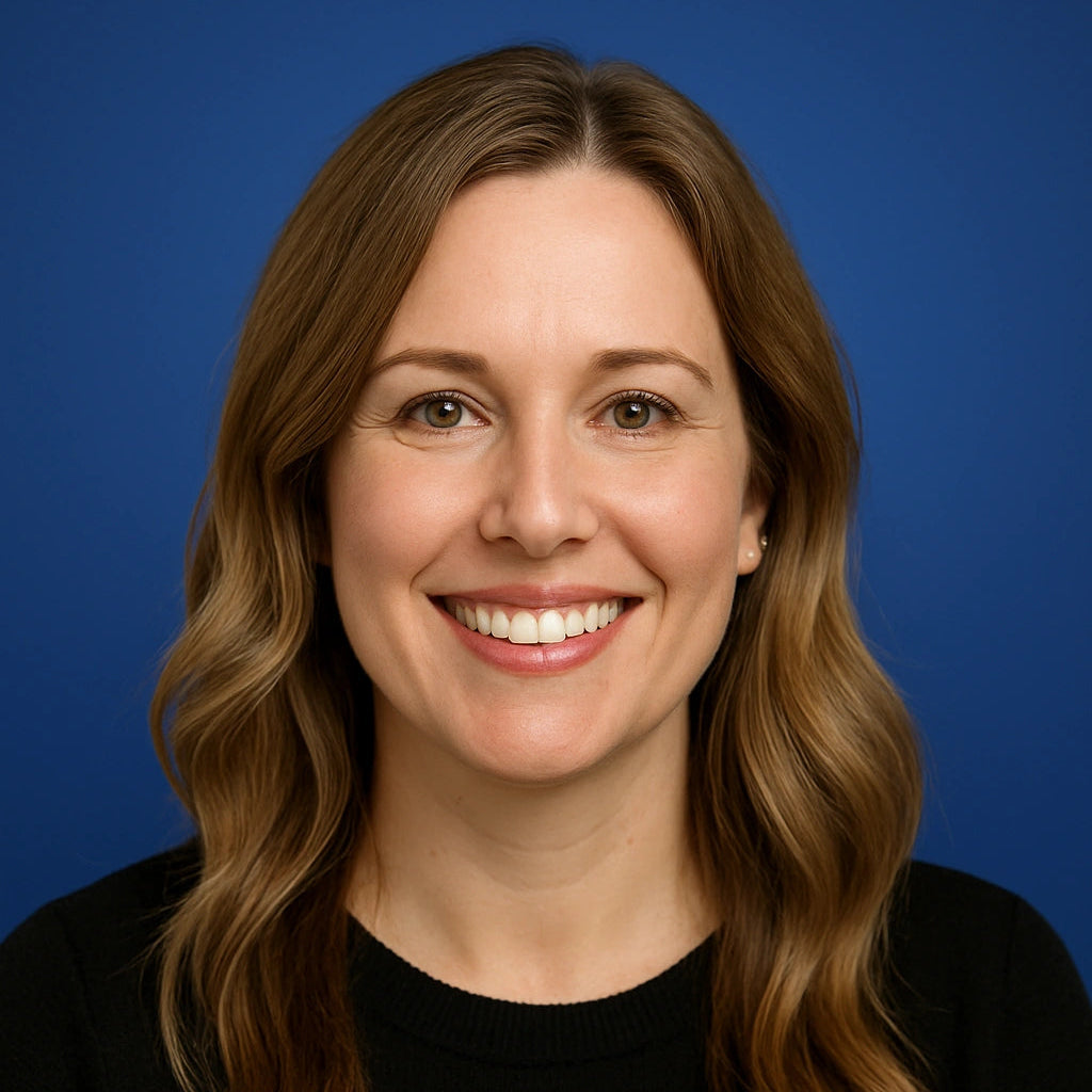 Professional headshot of Lauren Whitfield, Project Manager at Authority Ink Press, smiling in front of a blue studio background.