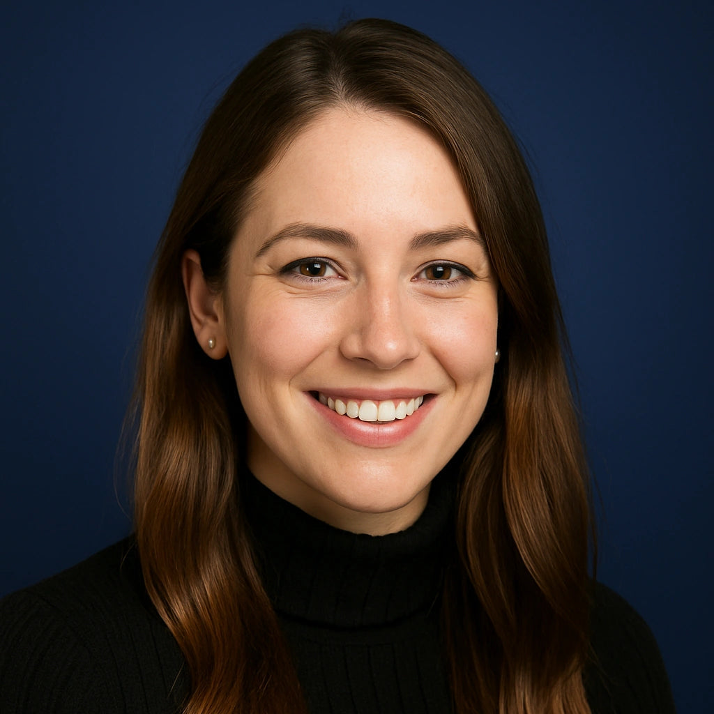 Professional headshot of Madison Clarke, Project Manager at Authority Ink Press, smiling in front of a dark blue studio background.