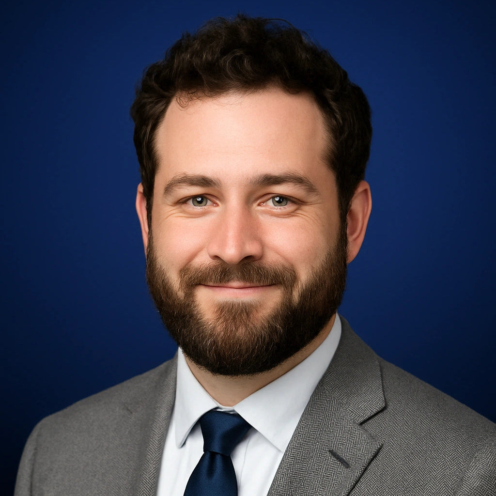 Professional headshot of Nathan Cole, Writer at Authority Ink Press, smiling in front of a dark blue studio background.